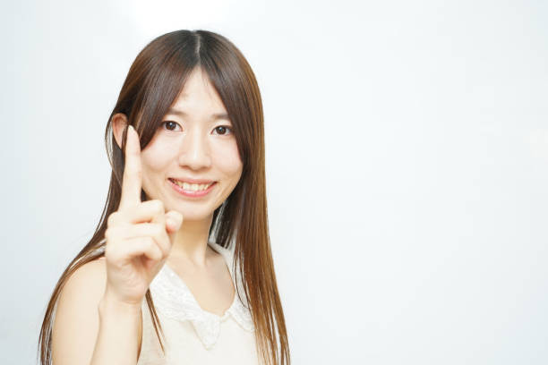 istock Young woman pointing something with white  background 641014928