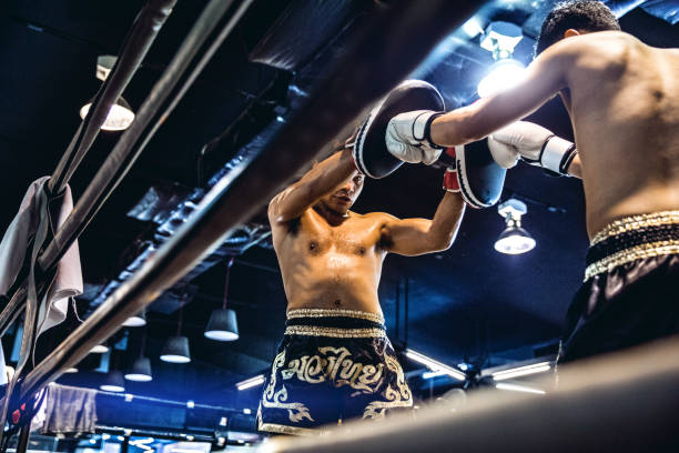 istock Muay Thai match on boxing ring in Thailand 641016926