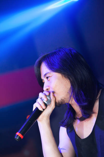istock Thai rock singer singing in night club 641020196