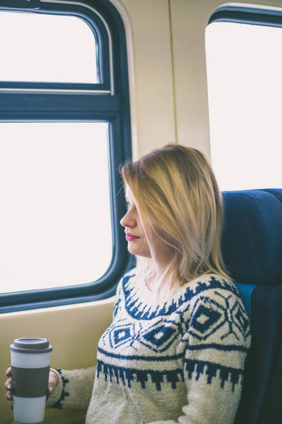 istock Young woman traveling looking out the window while sitting 641022458