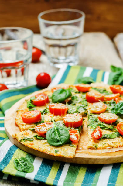 istock Cauliflower pizza crust with tomato and spinach 641023994