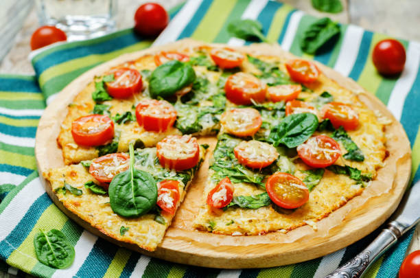 istock Cauliflower pizza crust with tomato and spinach 641023996