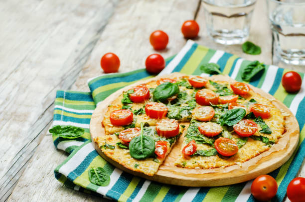 istock Cauliflower pizza crust with tomato and spinach 641023998