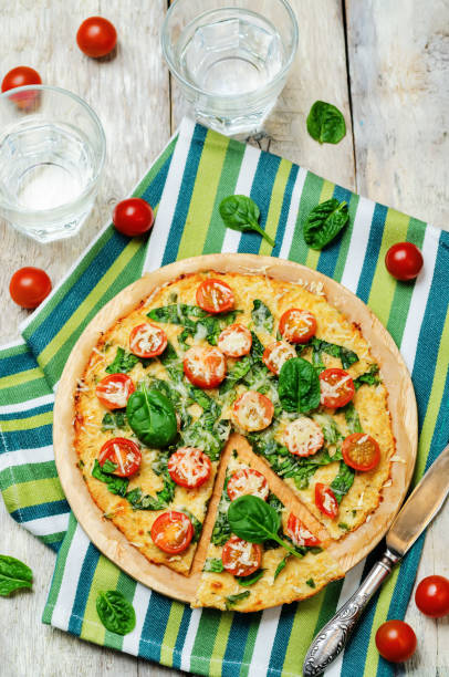 istock Cauliflower pizza crust with tomato and spinach 641024000