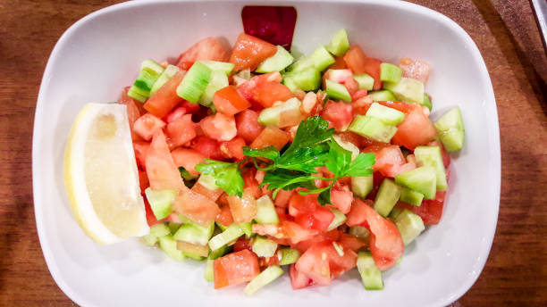 istock Turkish Coban salata or Shepherds salad in white bowl. 641024440