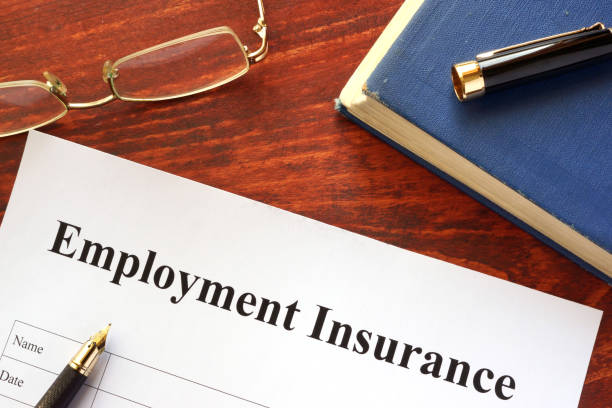 istock Employment Insurance form on a wooden surface. 641026722