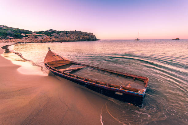 istock Wooden boat wrecked on a sandy beach. 641027894