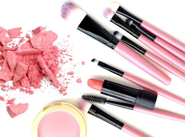istock Crushed make up powder and lipstick samples with brushes on white background 641027922