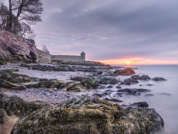 Beautiful sunrise over rocky beach near Kirkcaldy, Scotland stock photo