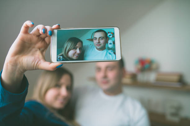 istock Couple in bed taking a selfie and having fun 641030056