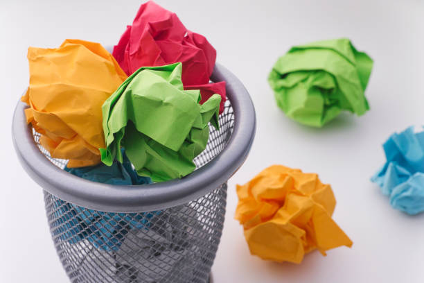 Colorful paper balls in a trash can