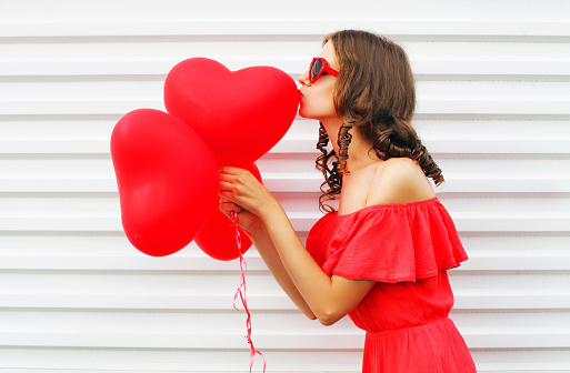Pretty Woman In Red Dress Kissing Air Balloons Heart Shape Over White ...
