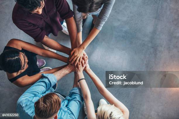 Students Making A Stack Of Hands Stock Photo - Download Image Now - Teamwork, Community, Multiracial Group
