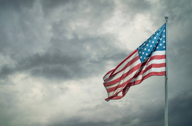 istock American flag on a dark cloudy 641034722