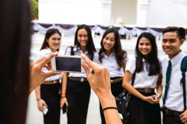 istock Thai students in uniform in Bangkok take a break together 641037716