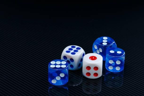 istock blue and white dices on the glossy black background 641040728