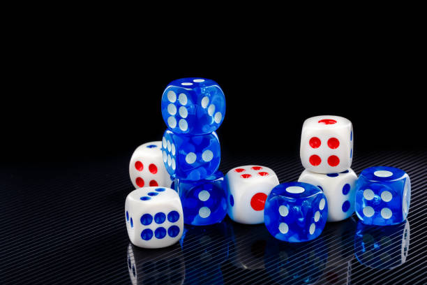 istock blue and white dices on the glossy black background 641041088