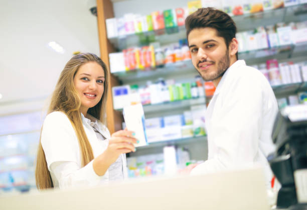 istock Two smiling friendly pharmacists working in luxury pharmacy 641041574