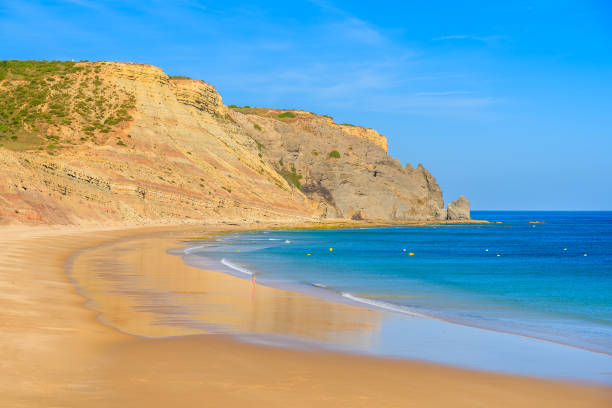 Beautiful bay and beach with azure sea in Luz town, Algarve region, Portugal Algarve region in south of Portugal is very popular tourist destination luz solar stock pictures, royalty-free photos & images