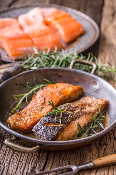 istock Grilled salmon herb decoration on vintage pan or slate board. 641042908