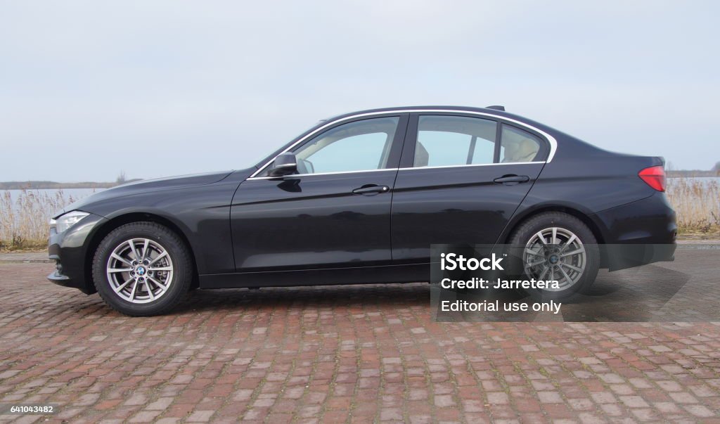Black BMW 320i Almere, Flevoland, The Netherlands - Februari 5, 2017: Black BMW 320I parked by the side of the road in the city of Almere. Nobody in the vehicle. BMW 3-Series Stock Photo