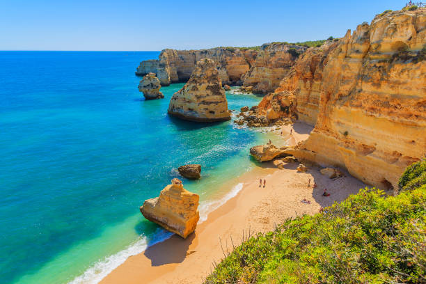 View of beautiful Marinha beach with crystal clear turquoise water near Carvoeiro town, Algarve region, Portugal Algarve region in south of Portugal is very popular tourist destination praia da marinha stock pictures, royalty-free photos & images