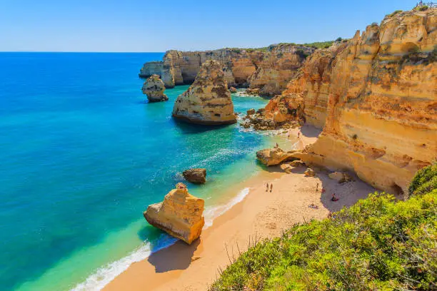 Photo of View of beautiful Marinha beach with crystal clear turquoise water near Carvoeiro town, Algarve region, Portugal