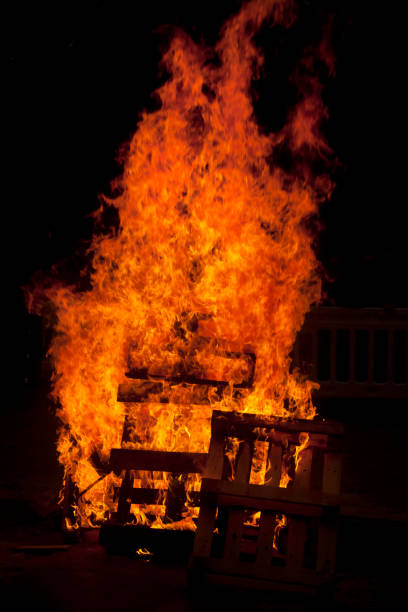 istock Large bonfire, wood burning, night black background. 641044234
