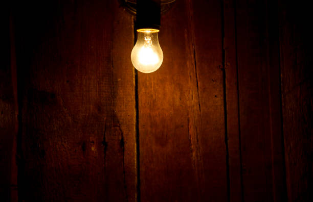 istock Electric light bulb on the wooden background 641045338