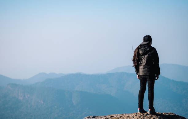 istock asian girl standing alone  at mountain 641045378