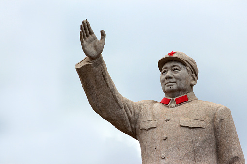 LIJIANG, CHINA, MARCH 8, 2012: Statue of Mao Zedond in central Lijiang. The city is famous for its UNESCO Heritage Site, the Old Town of Lijiang.