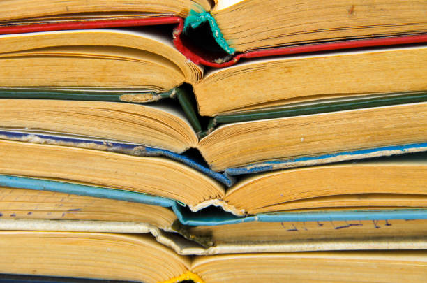 istock Stack of the old open books. Books background 641045588