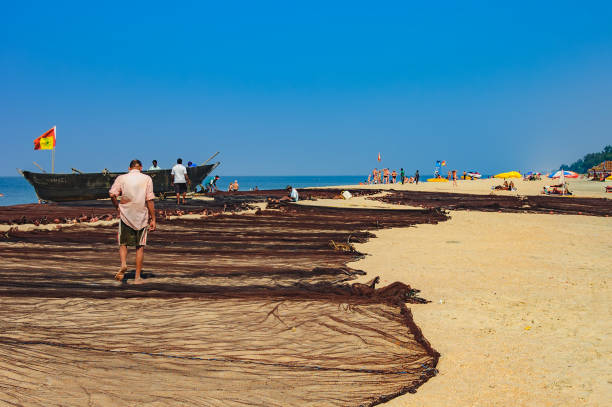 Colorful rowing boats on the long and wide beach of Nazaré, a seaside resort renowned throughout the world for its waves that attract numerous surfers