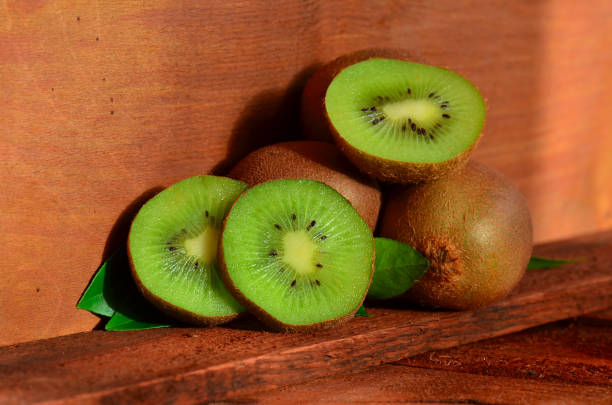 istock Kiwi on brown wooden background 641046688