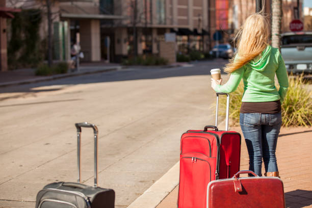 istock Woman traveling downtown with suitcases 641047894