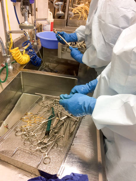 istock Two men hand washing medical intruments in sink 641048436