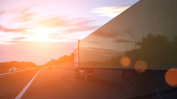 istock Cargo container truck highway road rural countryside sunset 641051520