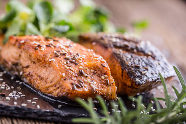 istock Grilled salmon herb decoration on vintage pan or slate board. 641052004