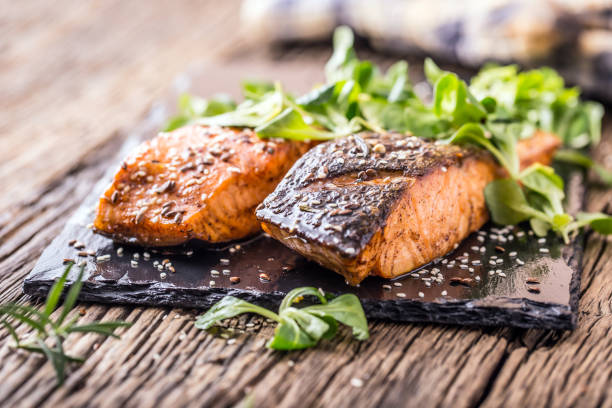 istock Grilled salmon herb decoration on vintage pan or slate board. 641052054