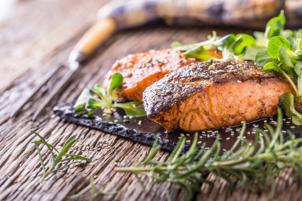 istock Grilled salmon herb decoration on vintage pan or slate board. 641052566