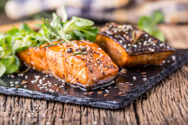 istock Grilled salmon herb decoration on vintage pan or slate board. 641052662