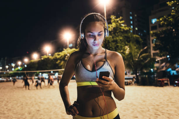 istock young fit woman using her smartphone after workout 641053546