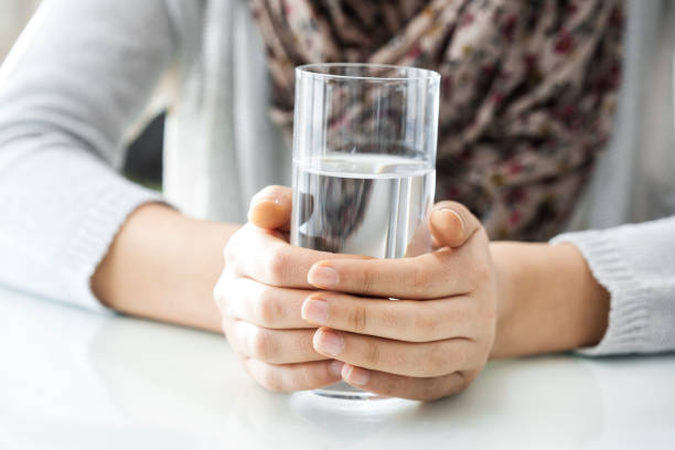 istock Woman hands holding water glass 641054766