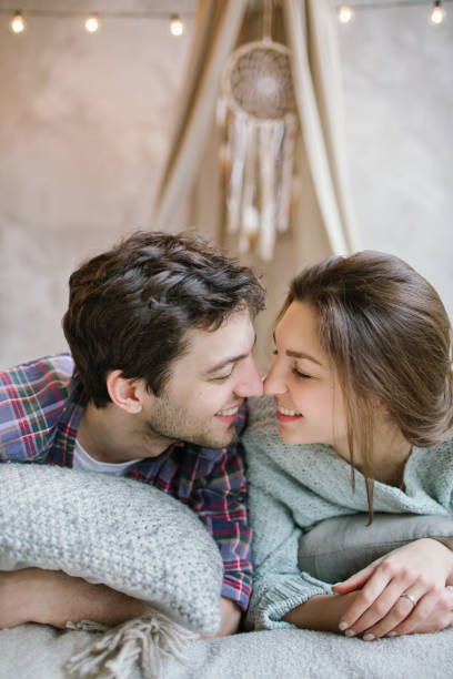 istock Young hipster couple having fun on handmade bed with dreamcatcher 641054796