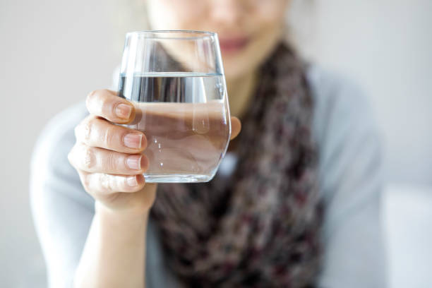istock Woman hands holding water glass 641055002