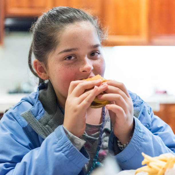 istock Young girl having a hamburger 641058550