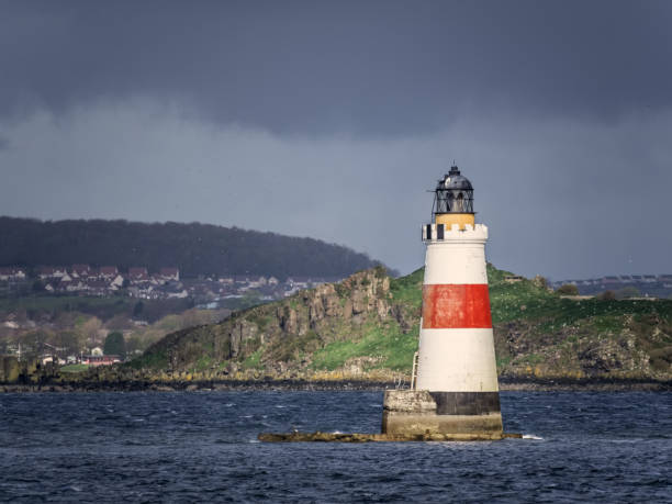 Oxcars white and red lighthouse in Scotland during sun splash stock photo