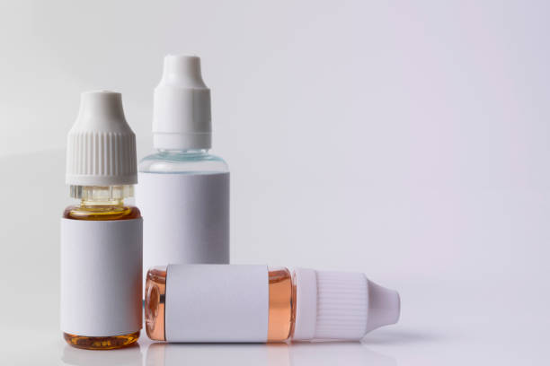 istock Isolated e liquid bottles for vaping devices and electronic cigarette on a white background. 641062092