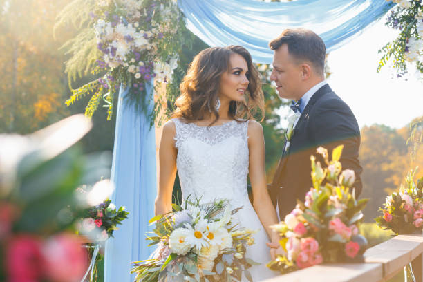 istock Elegant curly bride and happy groom 641063982