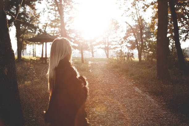 istock Woman in the local park during susnet 641065840